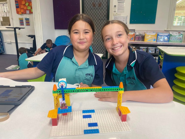 Two students int he classroom with their STEM design