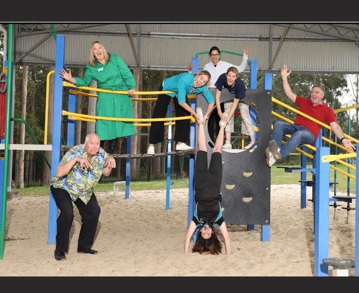 Fun image of staff on play equpiment