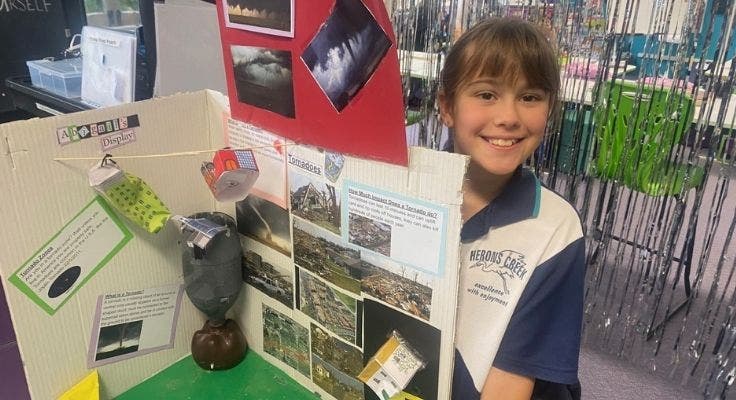 Student smiling with her project